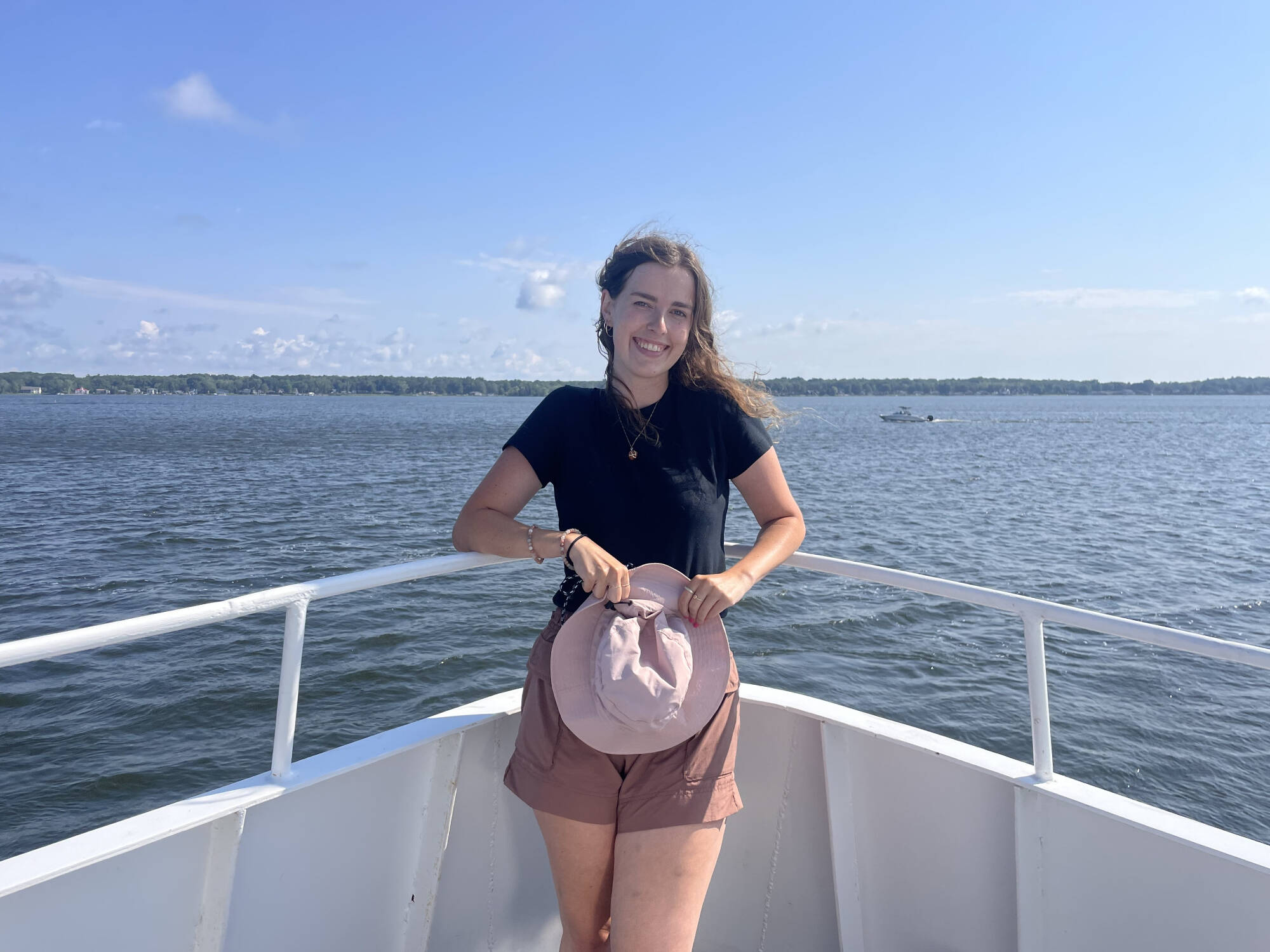 Jillian Green poses for a photo on the bow of the W.G. Jackson research vessel.